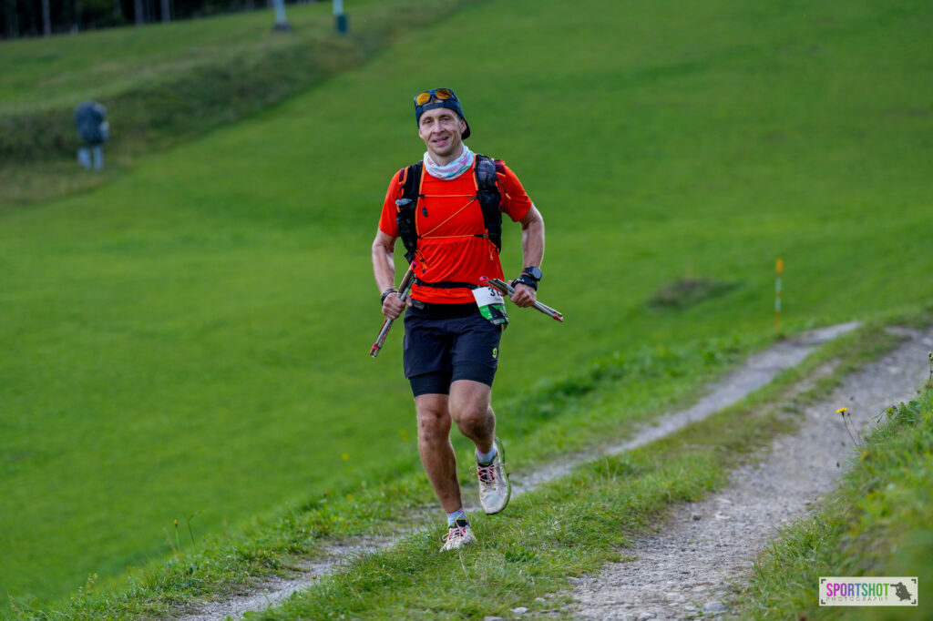 Läufer in Aktion beim OTF Trail-Wettkampf mit Startnummer, trägt den La Sportiva Prodigio auf einer Bergpassage.