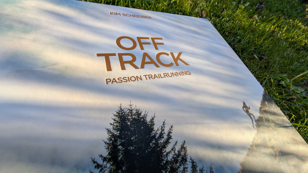 Nahaufnahme des Buchcovers 'OFF TRACK' von Kim Schreiber in einem stimmungsvollen Licht-und-Schatten-Spiel.
